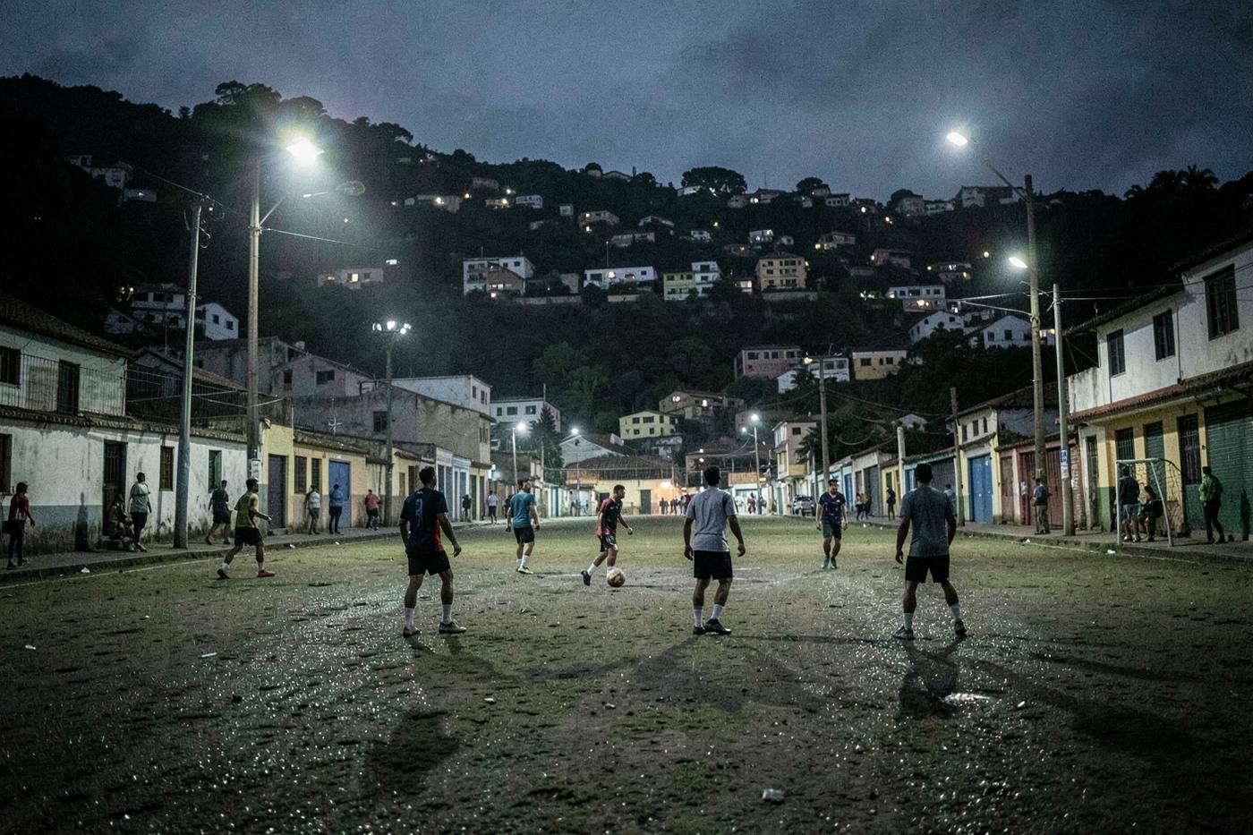 An evening football game in an urban neighbourhood